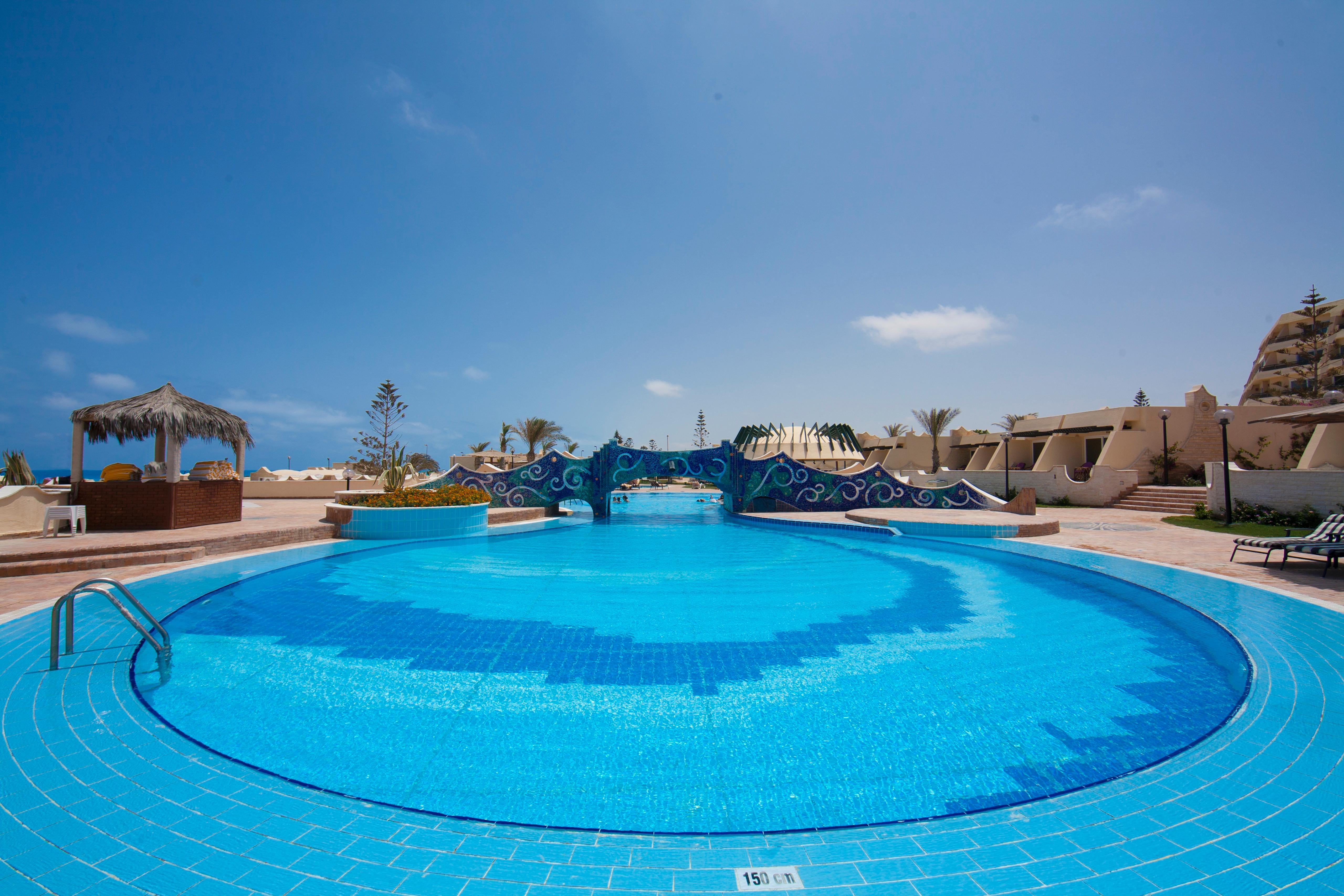 Borg El Arab Beach Resort Exterior foto A swimming pool at a resort in Egypt